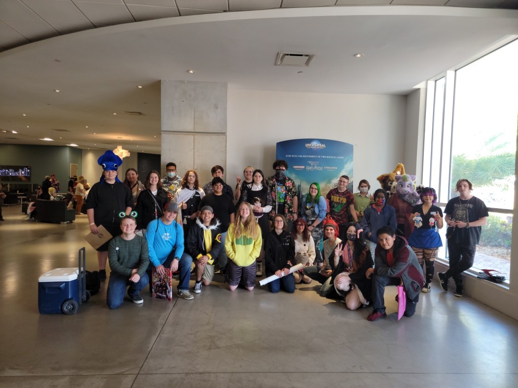 A whole bunch of kids who are in the anime club, grouped together to take a photo.