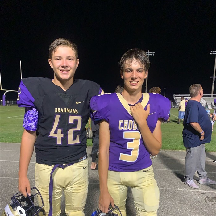 Matthew may (left) and Brady Williamson (right) pose for the camera, with happy expressions after the game.