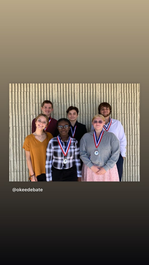 Students stand together with their medals.