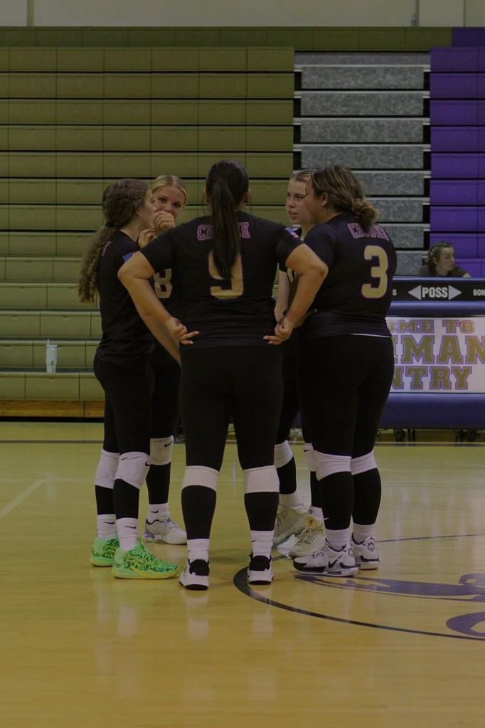 Jv (A) team talking together before the game starts. 