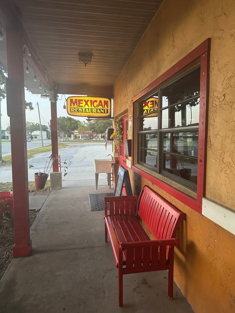 The side entrance/sign of Los Cocos where Prescott works.